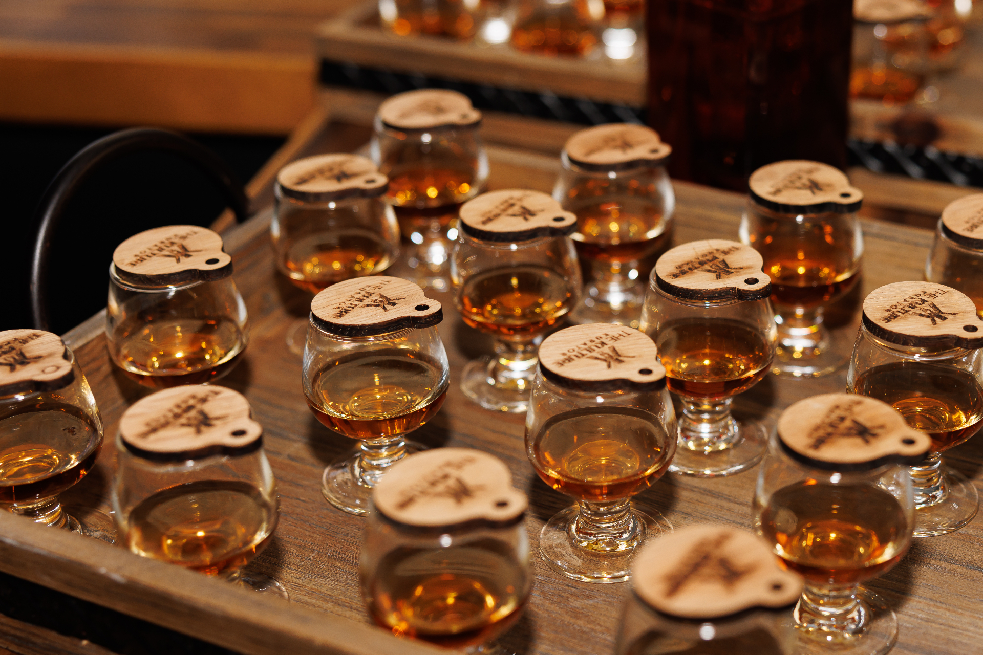A curated whiskey flight on wooden trays