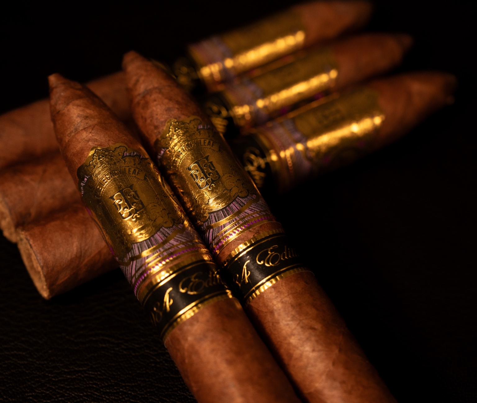 A premium Legacy Leaf cigar resting on walnut